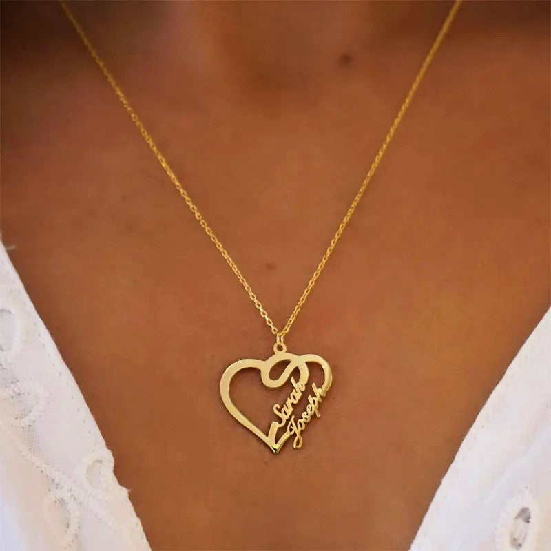 Women with white shirt wearing gold custom jewelry Heart Name Necklace