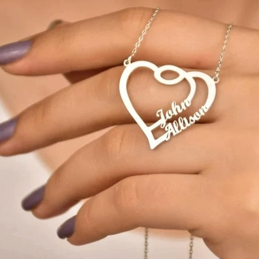 Woman holding a silver custom jewelry Heart Names Necklace